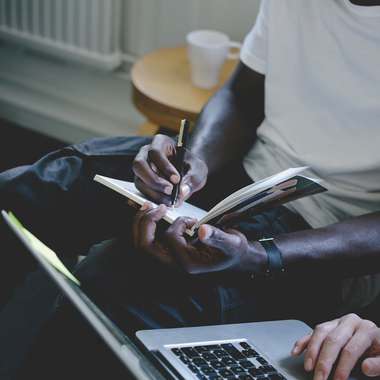 Man writing on note pad